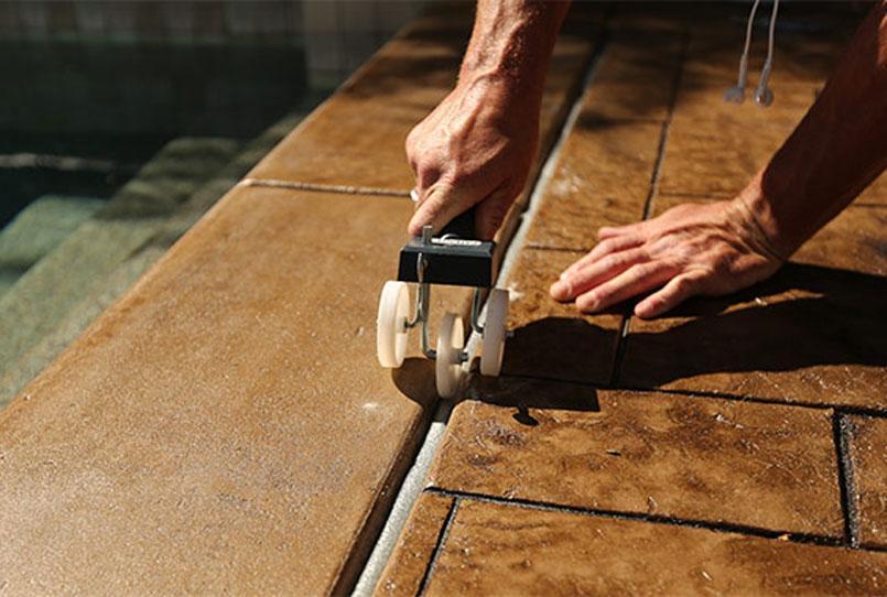 Pool sealant being placed by a pro